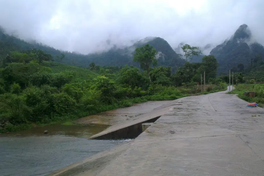 Crossing a river in Xuan son on a concrete path