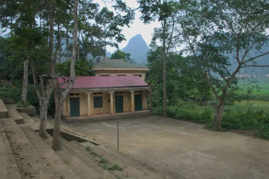 yellow house with a badminton court