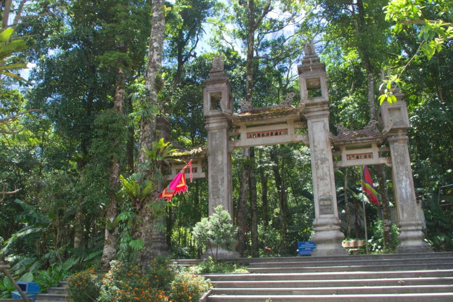 A large stone gateway for a jungle path leading to a temple