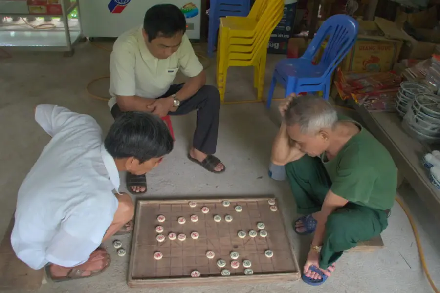 Men playing chess south of Ha Giang city we met on a motorbike tour