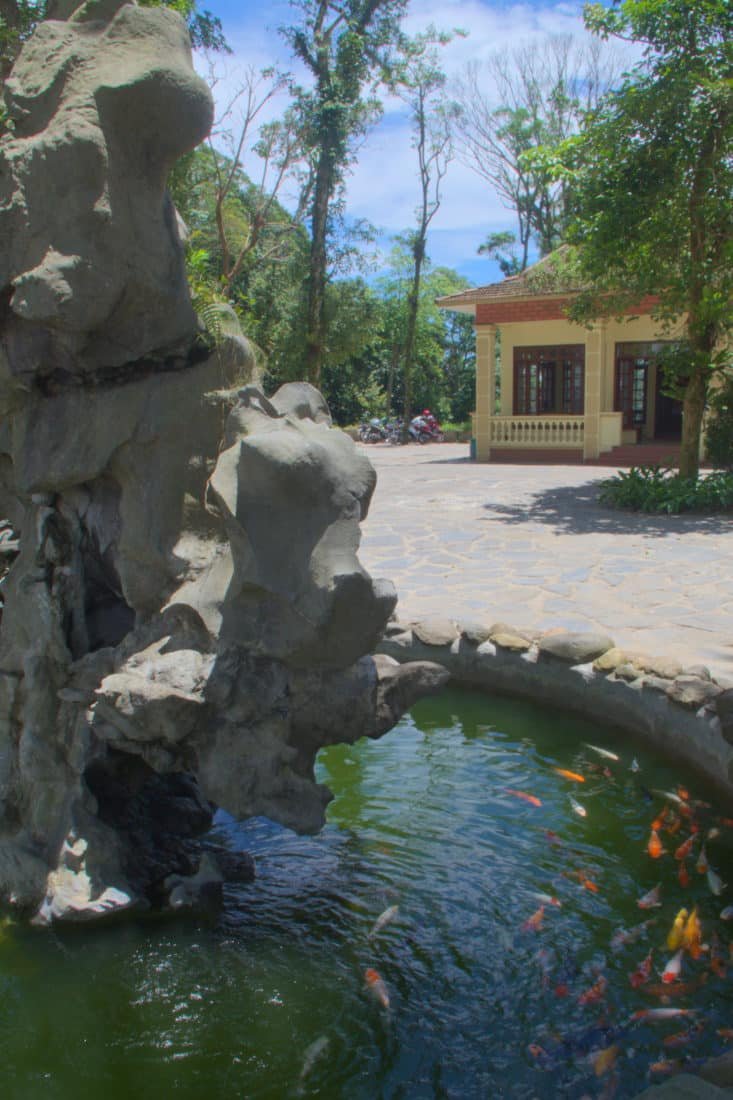 A Koi fish pond with a large stone boulder