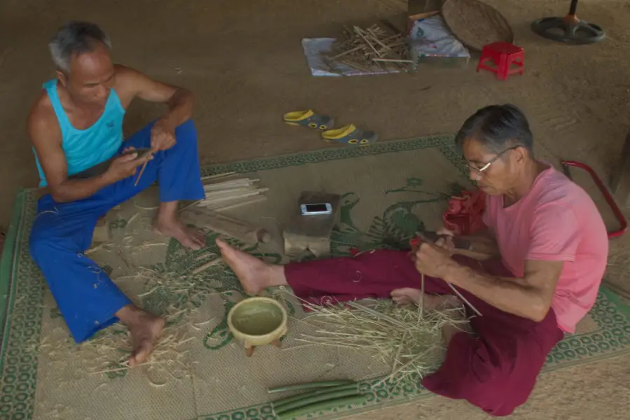 Vietnamese minority men making baskets and chopsticks near Ba Vi