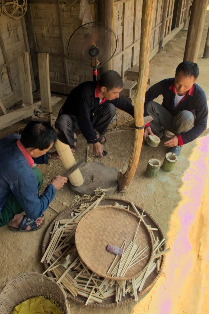 Minority men working with bamboo at a motorbike tour destination