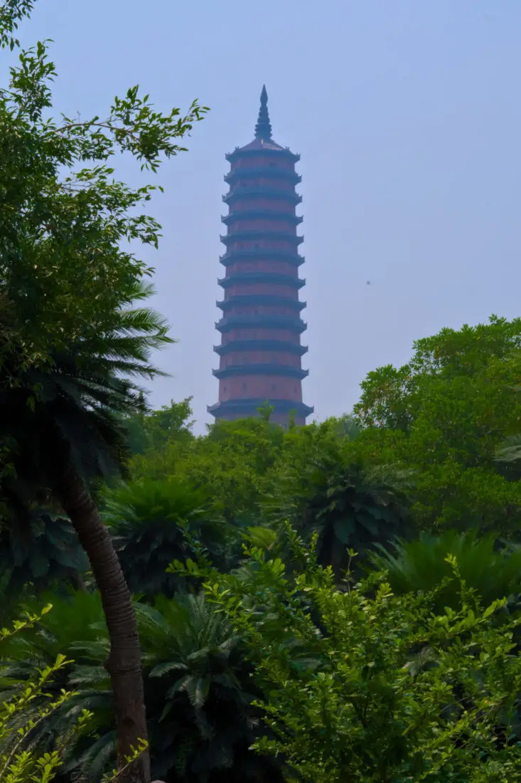 Stupa behind trees at Bai Dinh temple complex in Ninh Binh