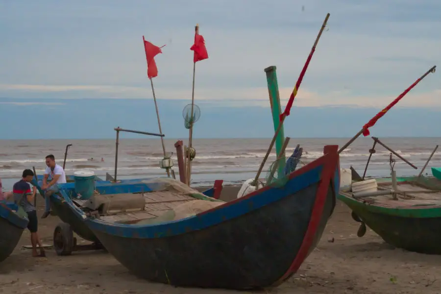 Fishing boats on the coast of Nam Dinh as seen on a motorbike tour with viettracks