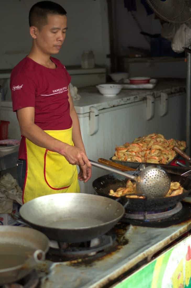 A vietnamese chef cooking prawn fritters