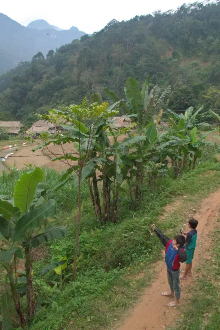 2 Vietnamese boys with slingshots in the countryside