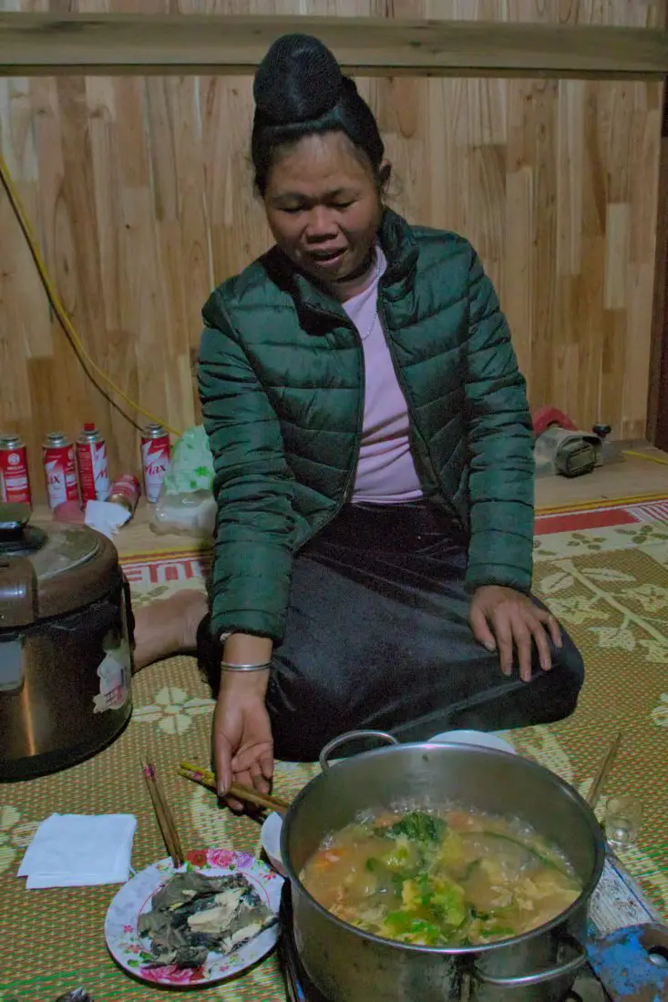 A black Thai lady eating hot pot in Vietnam