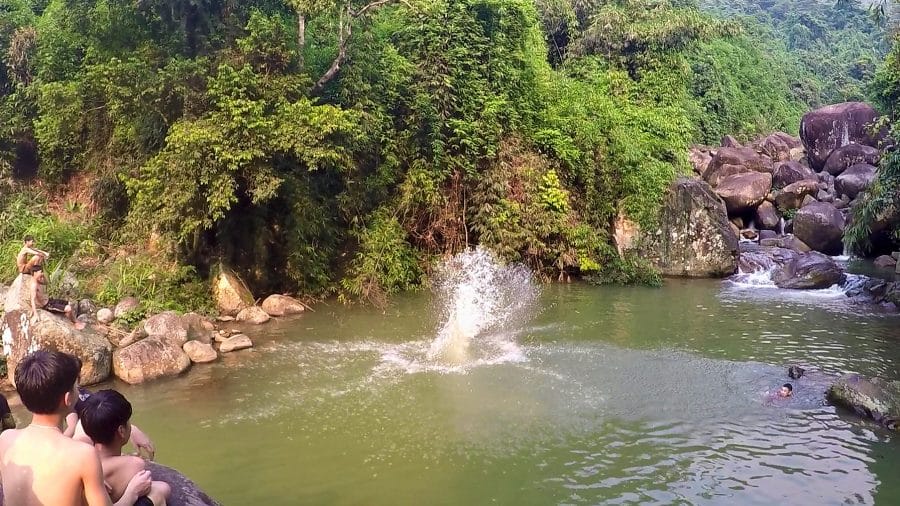 A splash of water from a boy jumping into a rock pool at Thac Mat Troi