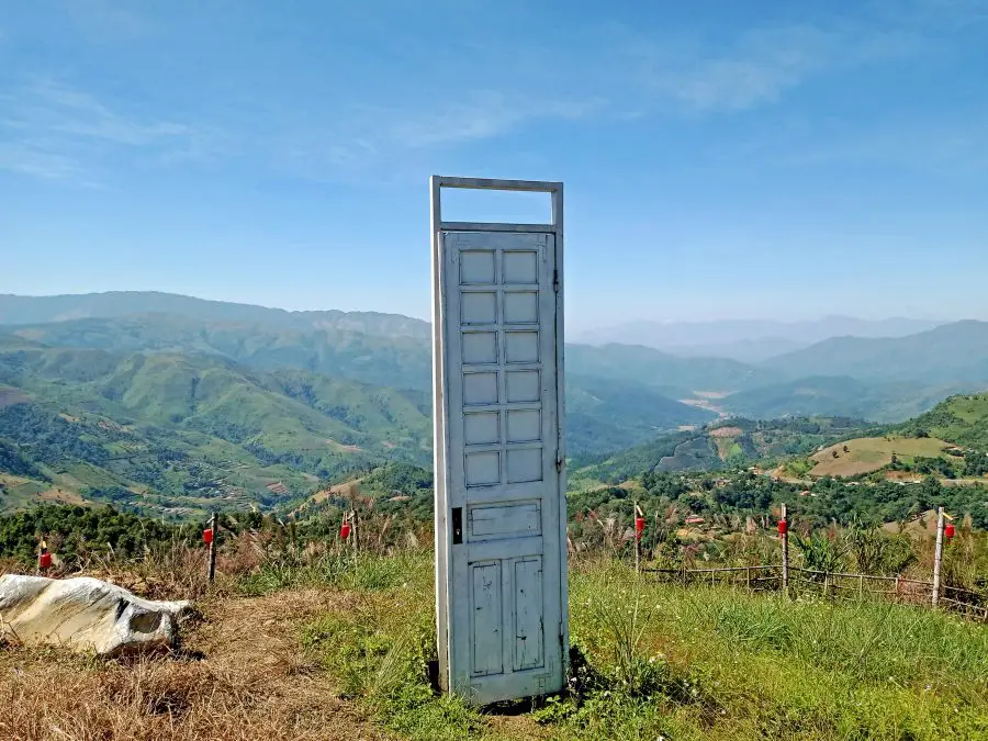 A mountain view with a door prop for photographs on the top of Pha Din pass 