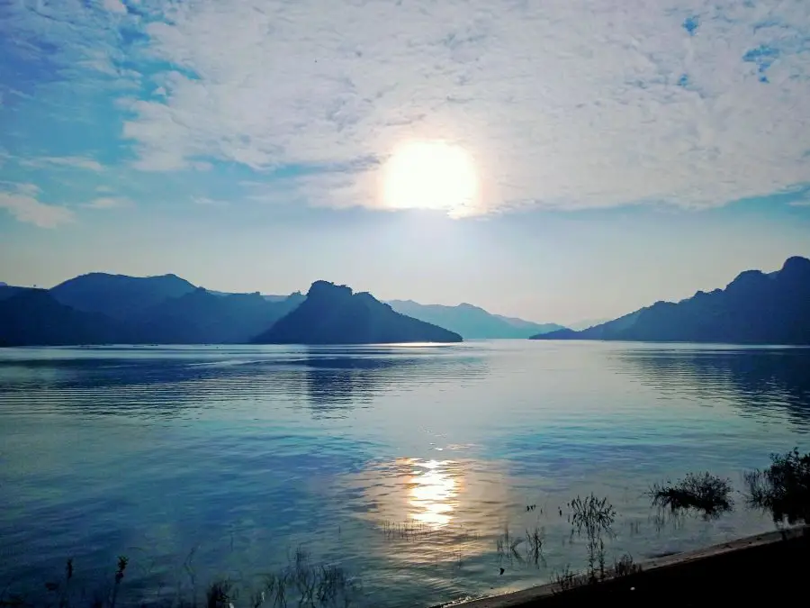A beautiful resevoir of blue water and mountains at sunset in Hoa Binh